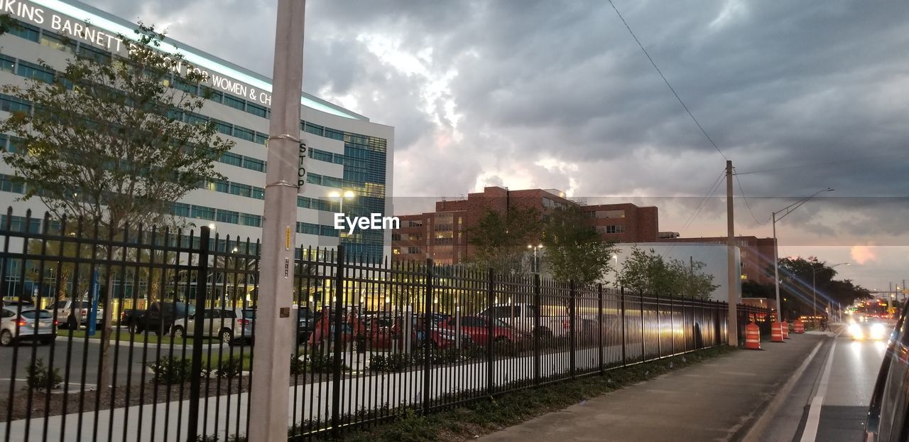 PANORAMIC VIEW OF RAILROAD TRACKS AMIDST BUILDINGS IN CITY