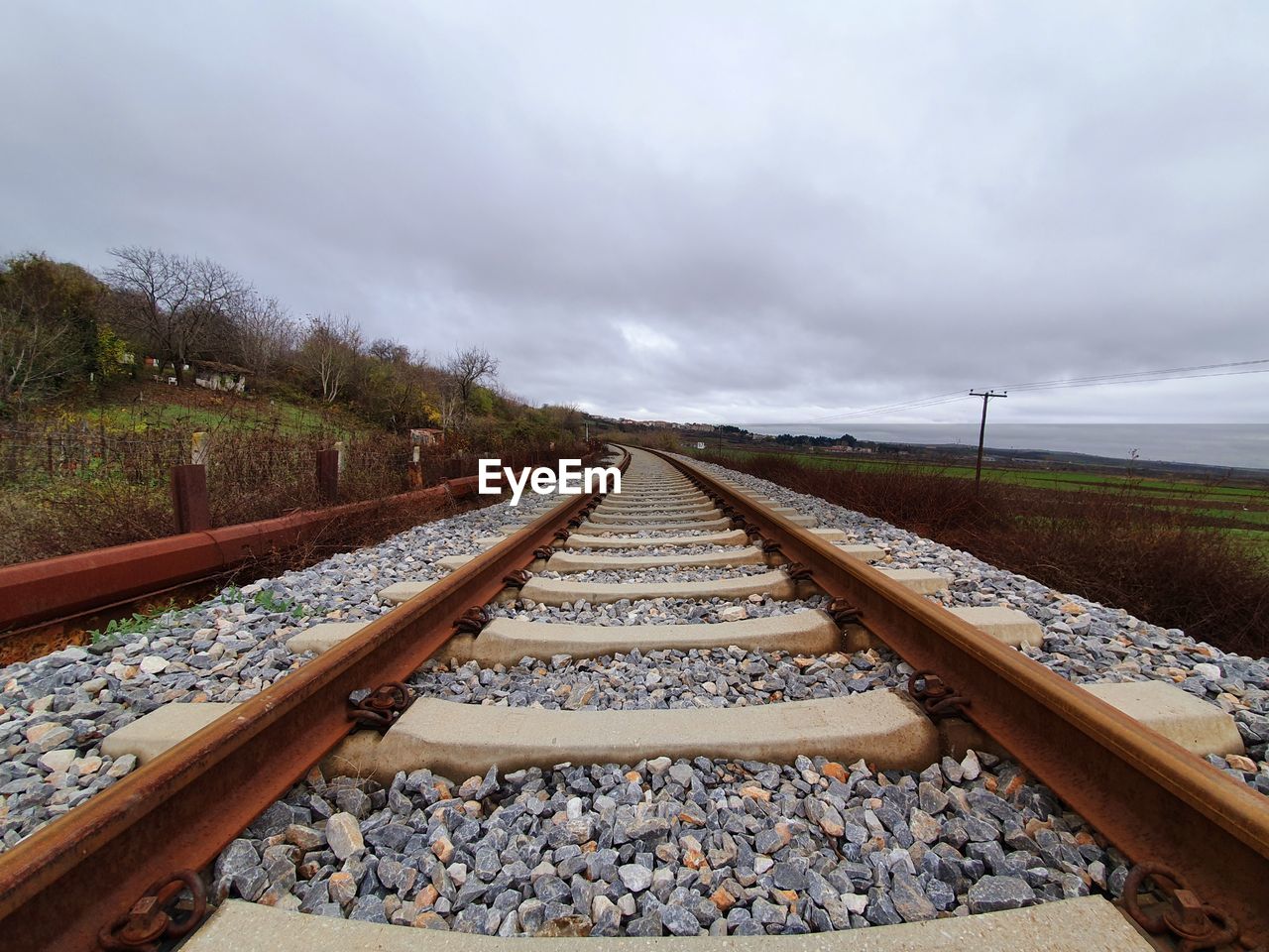 Surface level of railroad tracks against sky