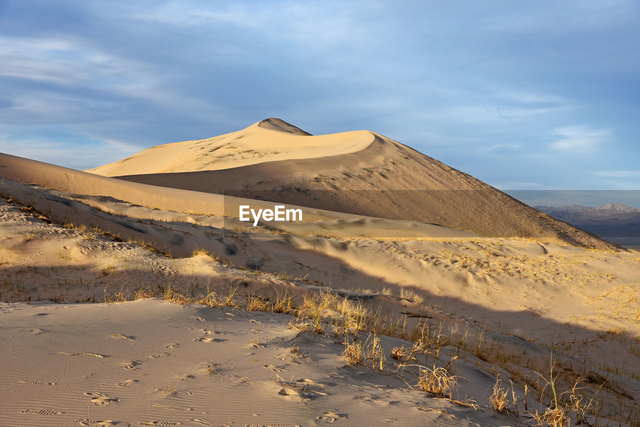 View of desert against cloudy sky