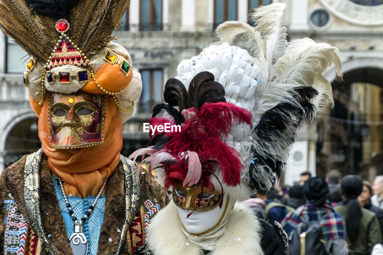 People wearing costume and masks during event