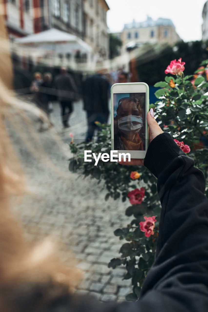 Teenage girl talking on video call while standing on street