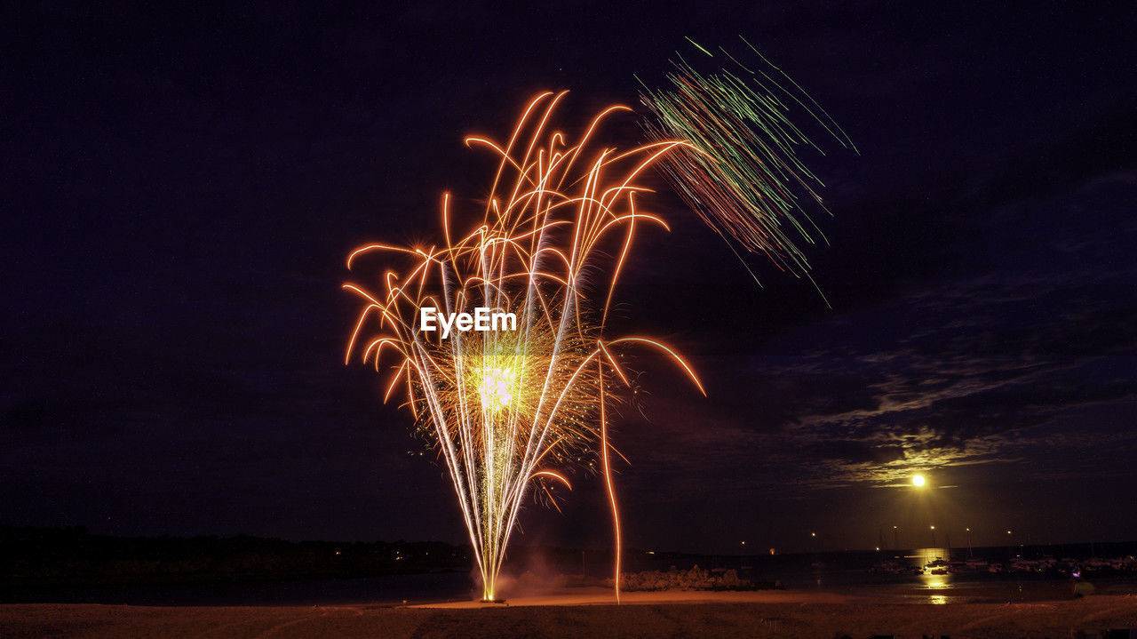 night, fireworks, illuminated, motion, long exposure, celebration, arts culture and entertainment, firework display, event, exploding, sky, glowing, nature, blurred motion, no people, outdoors, water, firework - man made object, recreation, land
