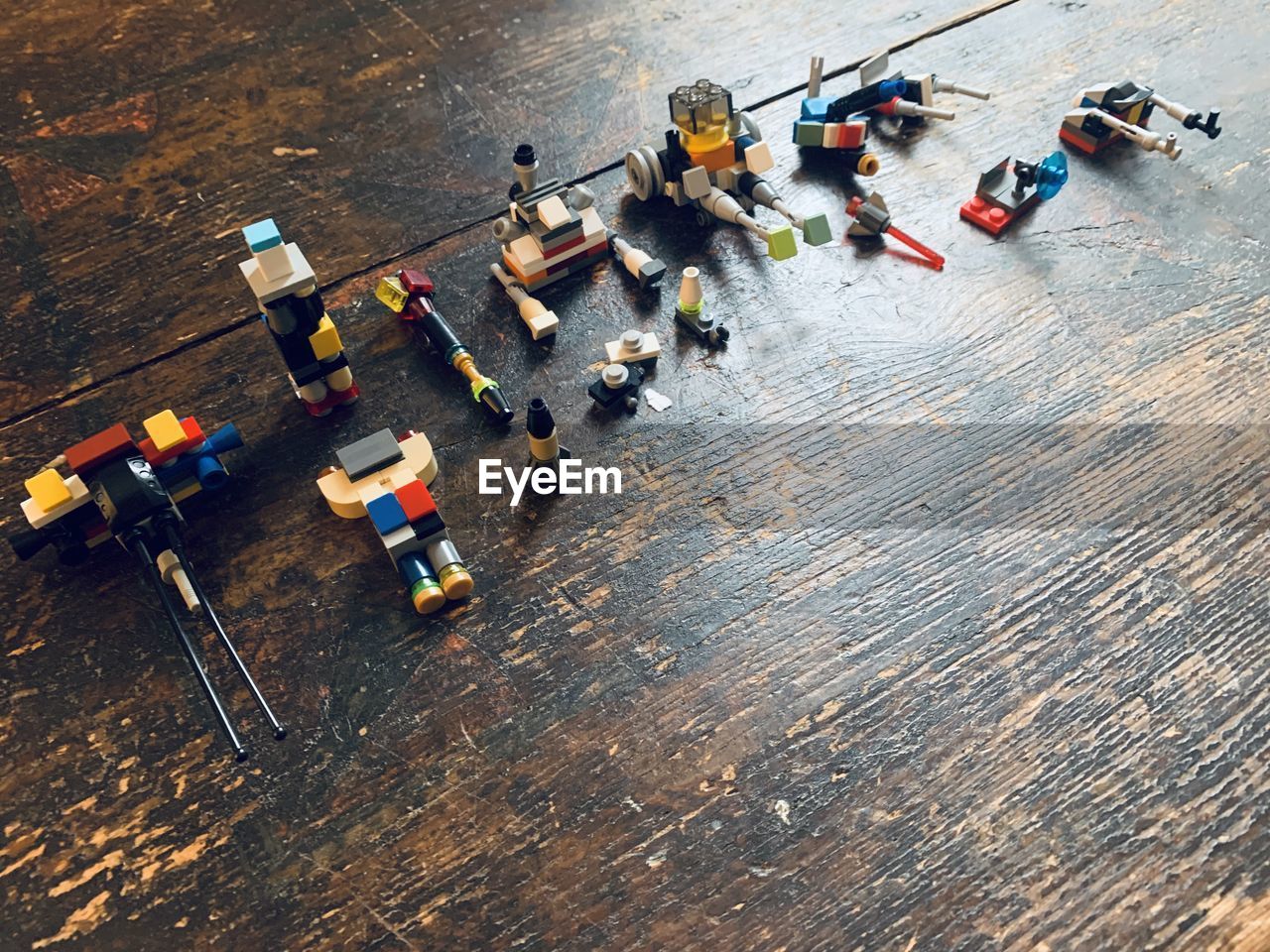 High angle view of group of toys on wood surface