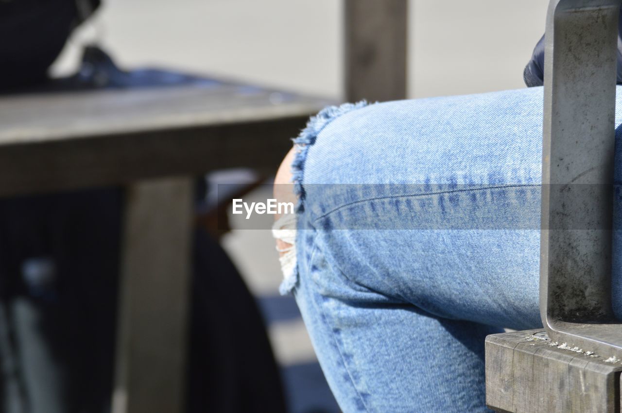 Close-up of man standing on metal