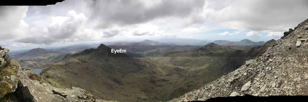 PANORAMIC VIEW OF MAJESTIC MOUNTAINS AGAINST SKY