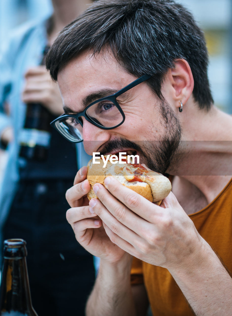 Close-up of man eating burger