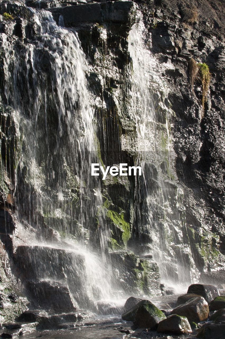 WATER FLOWING THROUGH ROCKS