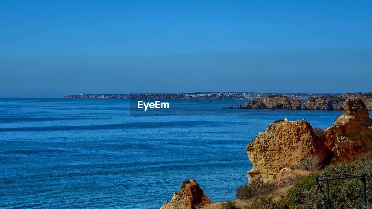 Scenic view of sea against blue sky