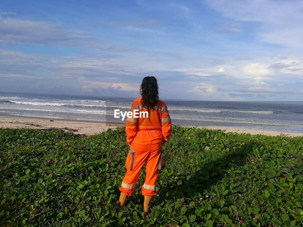 Rear view of woman looking at sea against sky