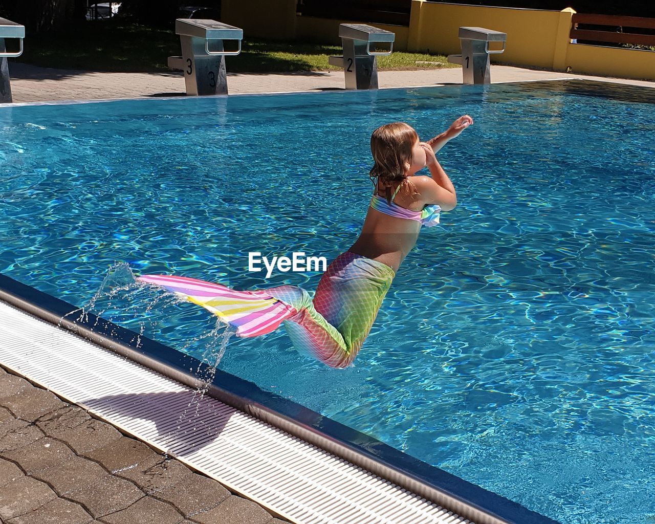 Full length of girl diving in swimming pool