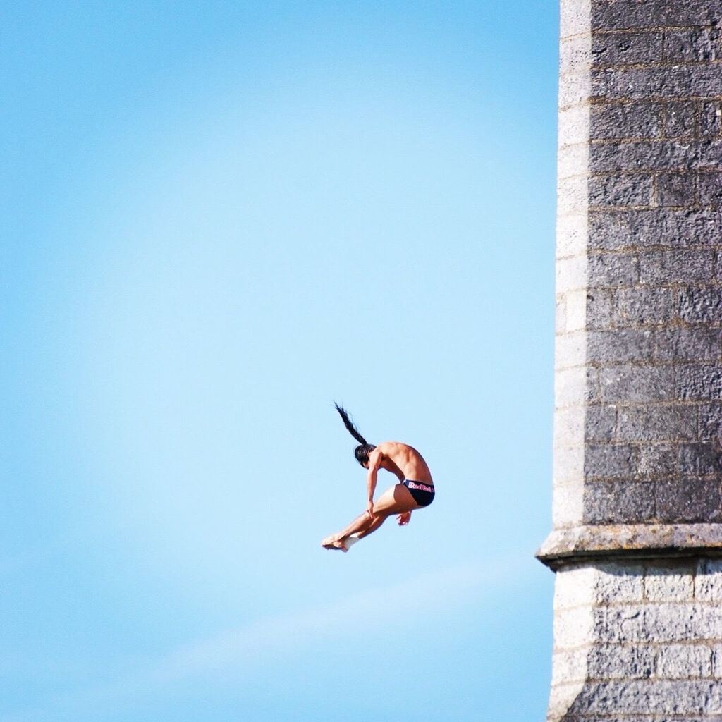 LOW ANGLE VIEW OF BIRD FLYING OVER BLUE SKY