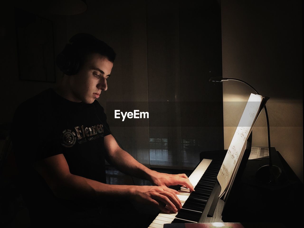YOUNG MAN PLAYING PIANO