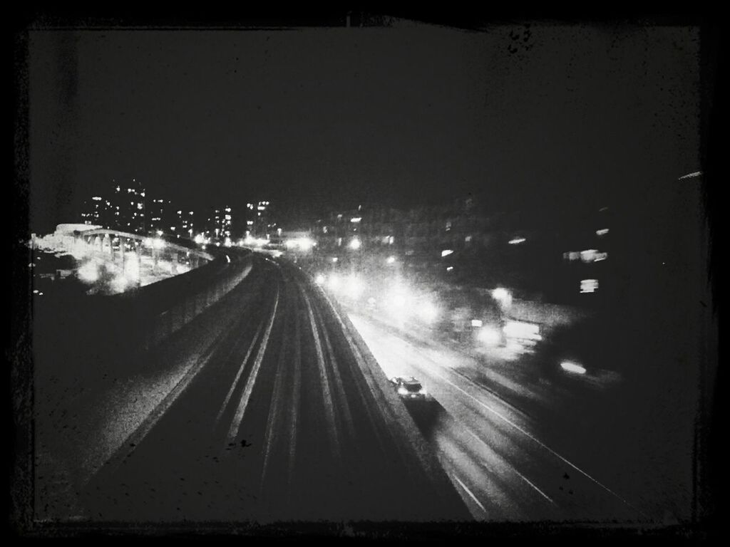 VIEW OF ILLUMINATED ROAD AT NIGHT