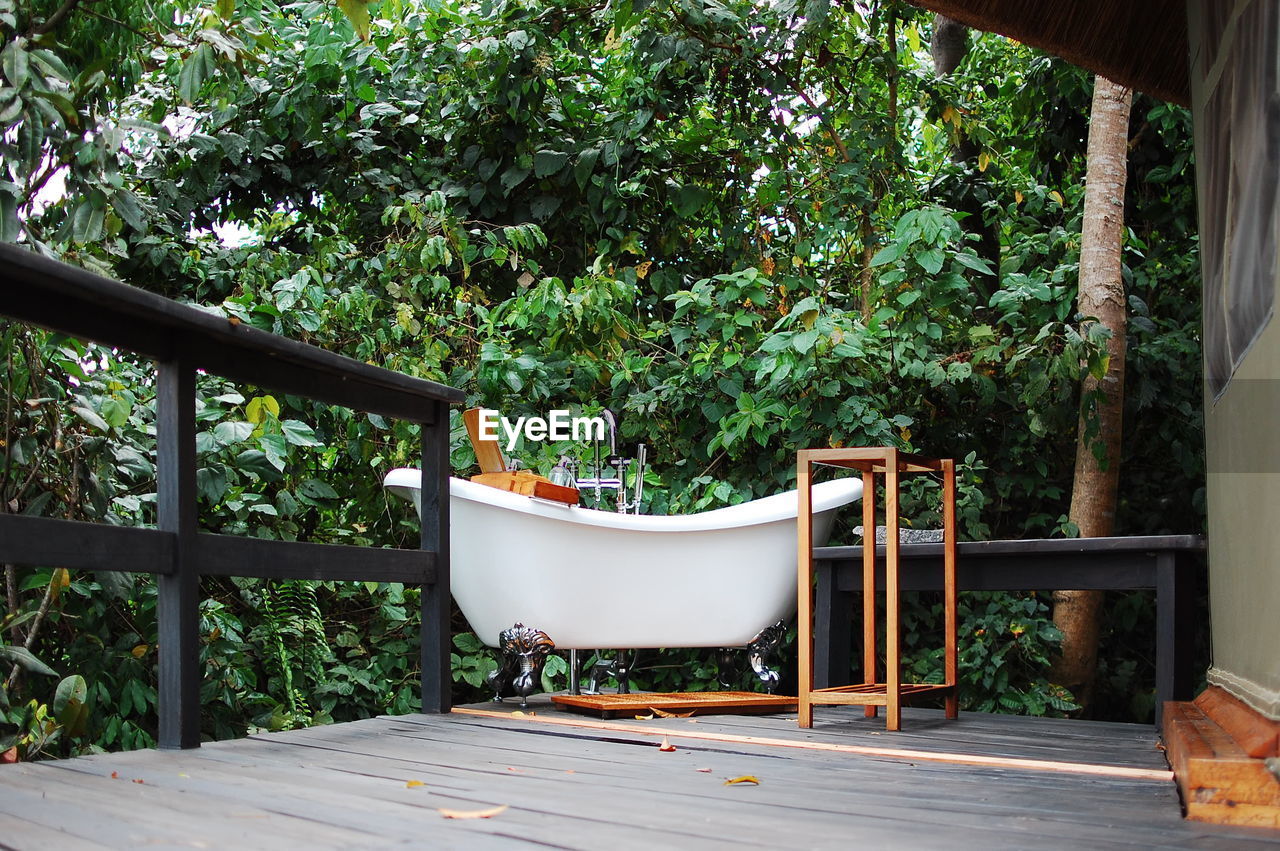 EMPTY CHAIRS AND TABLE IN YARD