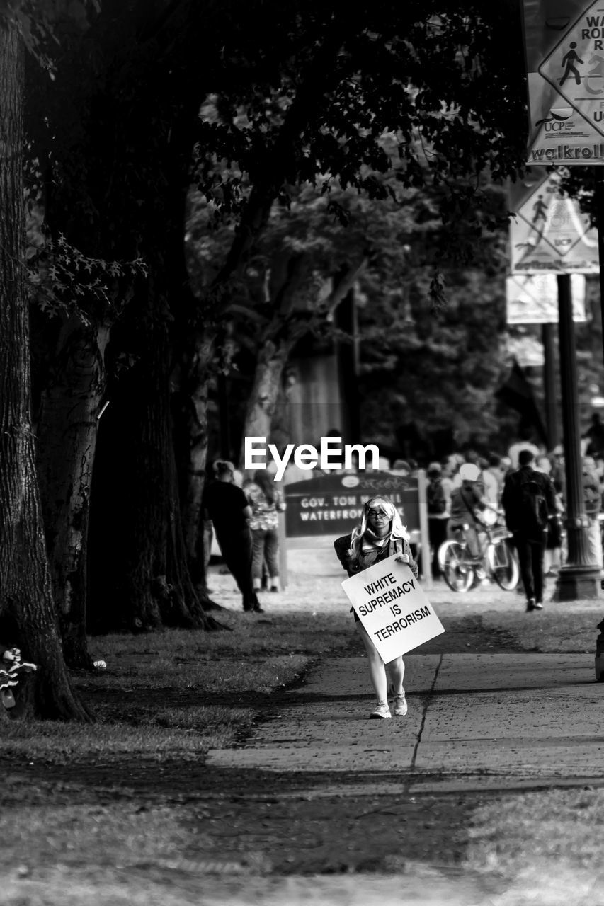 GROUP OF PEOPLE WALKING ON STREET