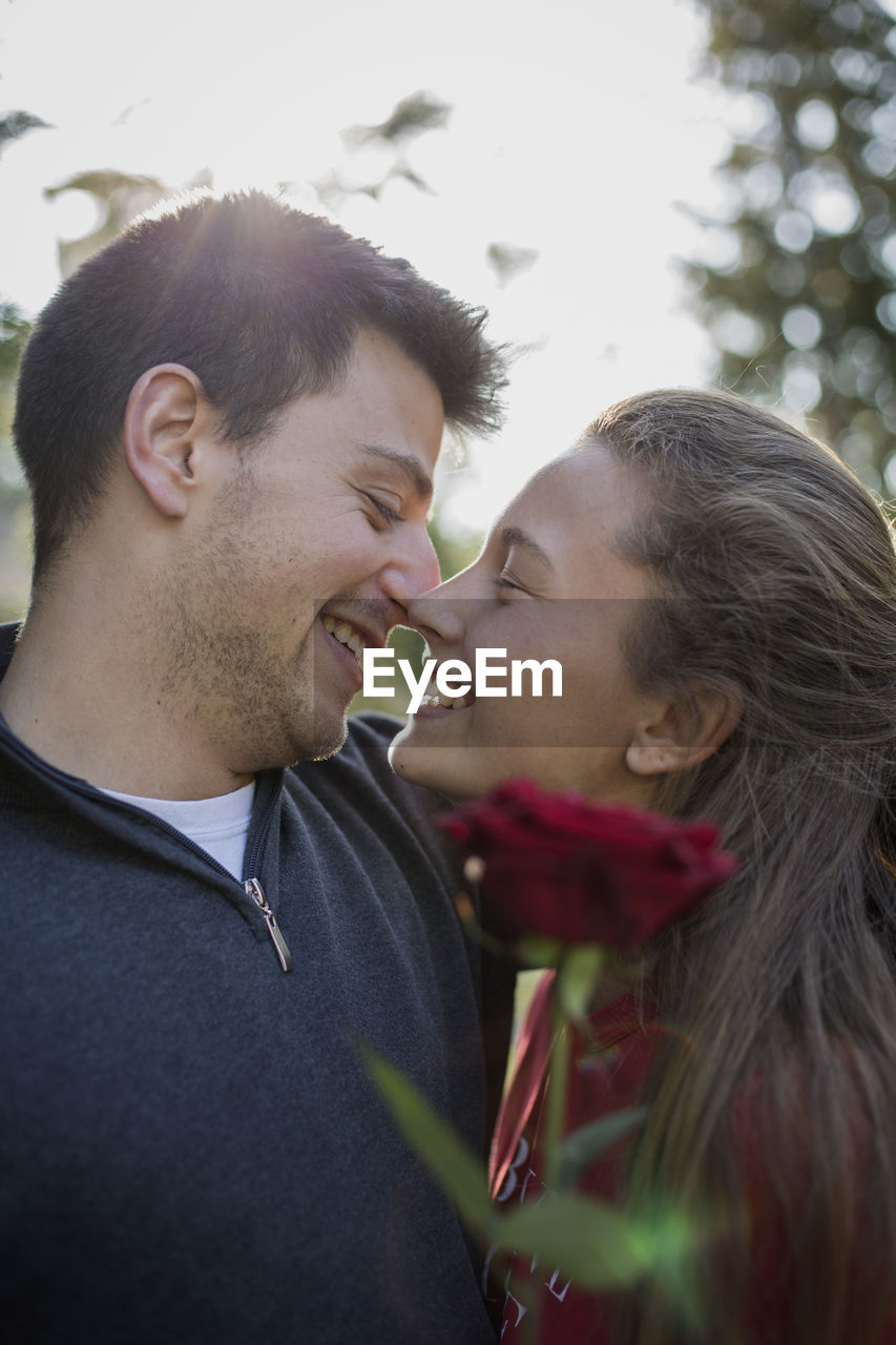 Close-up of couple kissing while standing outdoors