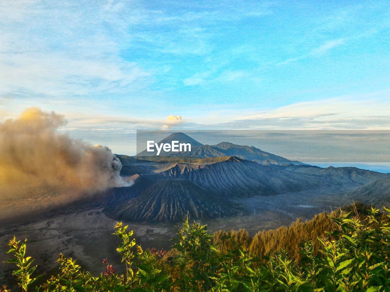 View of volcanic landscape against cloudy sky