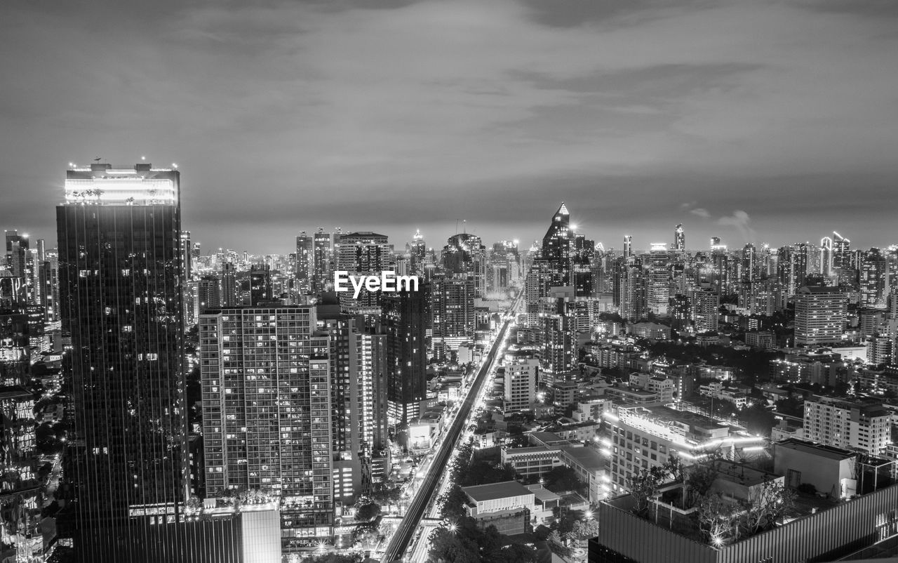 architecture, city, building exterior, built structure, metropolis, cityscape, building, office building exterior, skyscraper, skyline, metropolitan area, sky, urban area, landscape, urban skyline, black and white, illuminated, night, residential district, travel destinations, monochrome photography, nature, city life, downtown district, downtown, high angle view, monochrome, no people, tower block, cloud, horizon, development, office, tower, outdoors, travel, aerial photography, street, aerial view, business, dusk, transportation