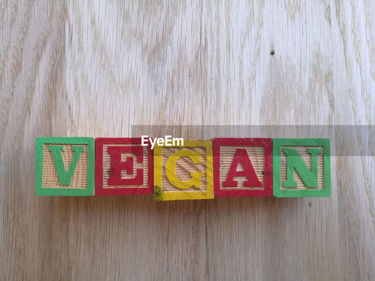 Text with toy blocks on wooden table