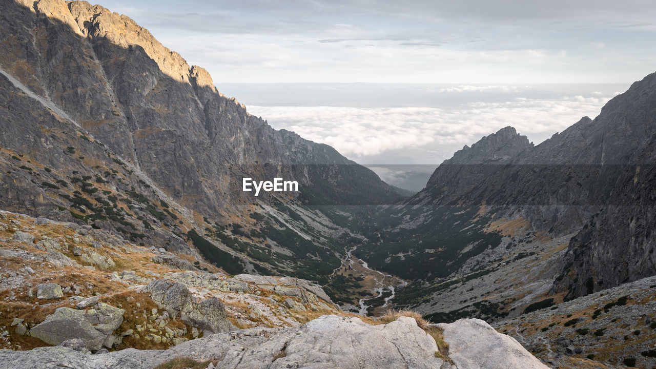Beautiful view on alpine valley with big mountains and low clouds behind, slovakia, europe
