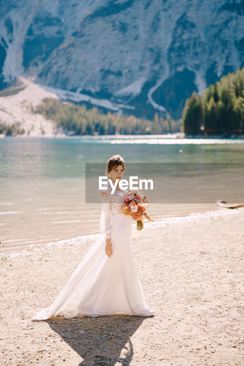 FULL LENGTH OF WOMAN WITH ARMS OUTSTRETCHED ON LAND