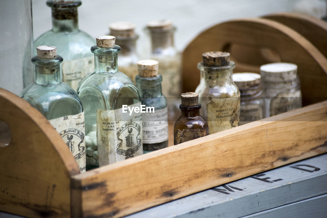 Close-up of bottles in wooden tray