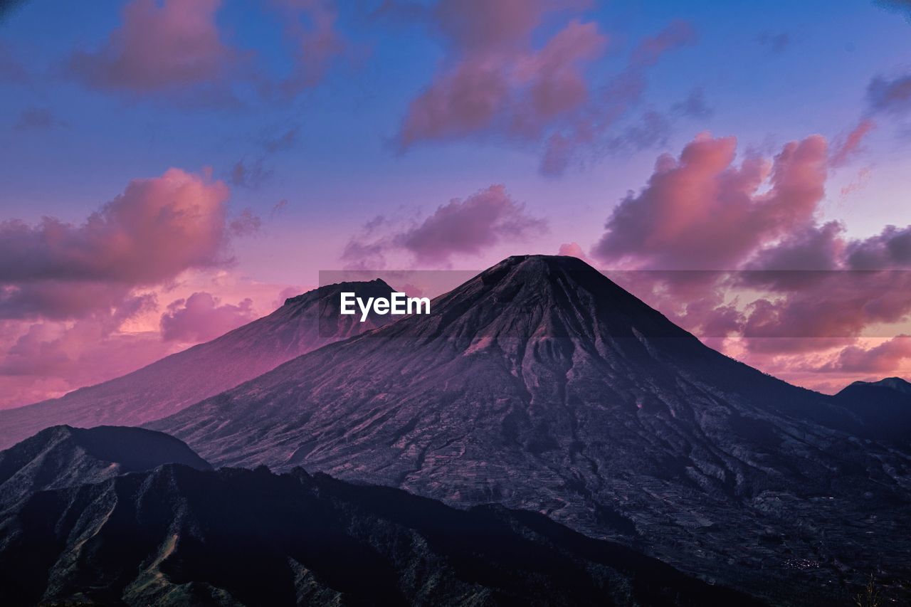 Scenic view of twin mountain, sumbing and sindoro against sky during sunset