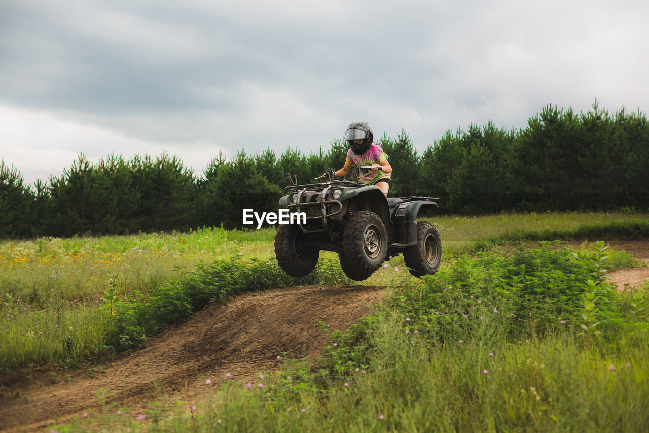 Teen girl catching air on atv track in northwestern wi