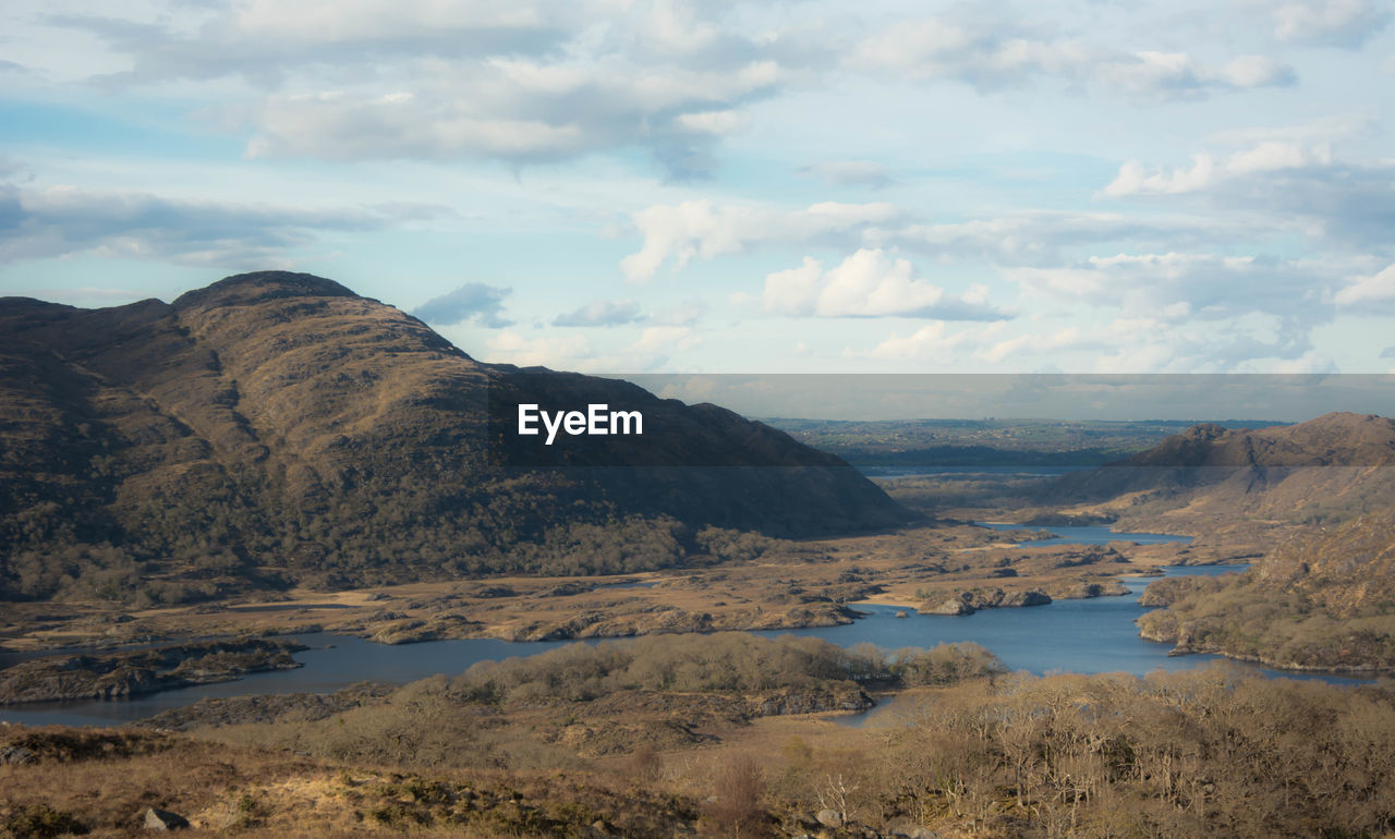 Scenic view of lake against cloudy sky