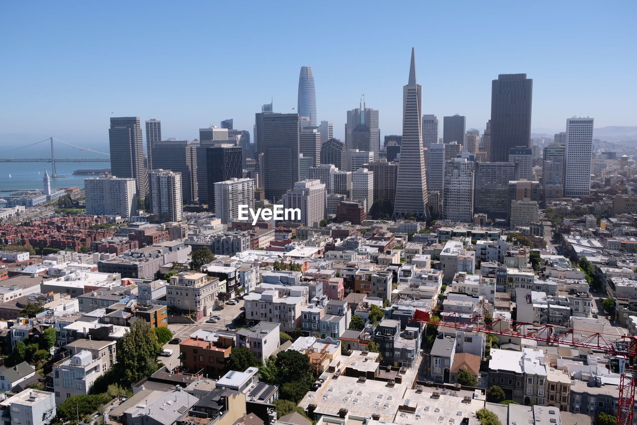 AERIAL VIEW OF BUILDINGS IN CITY AGAINST SKY