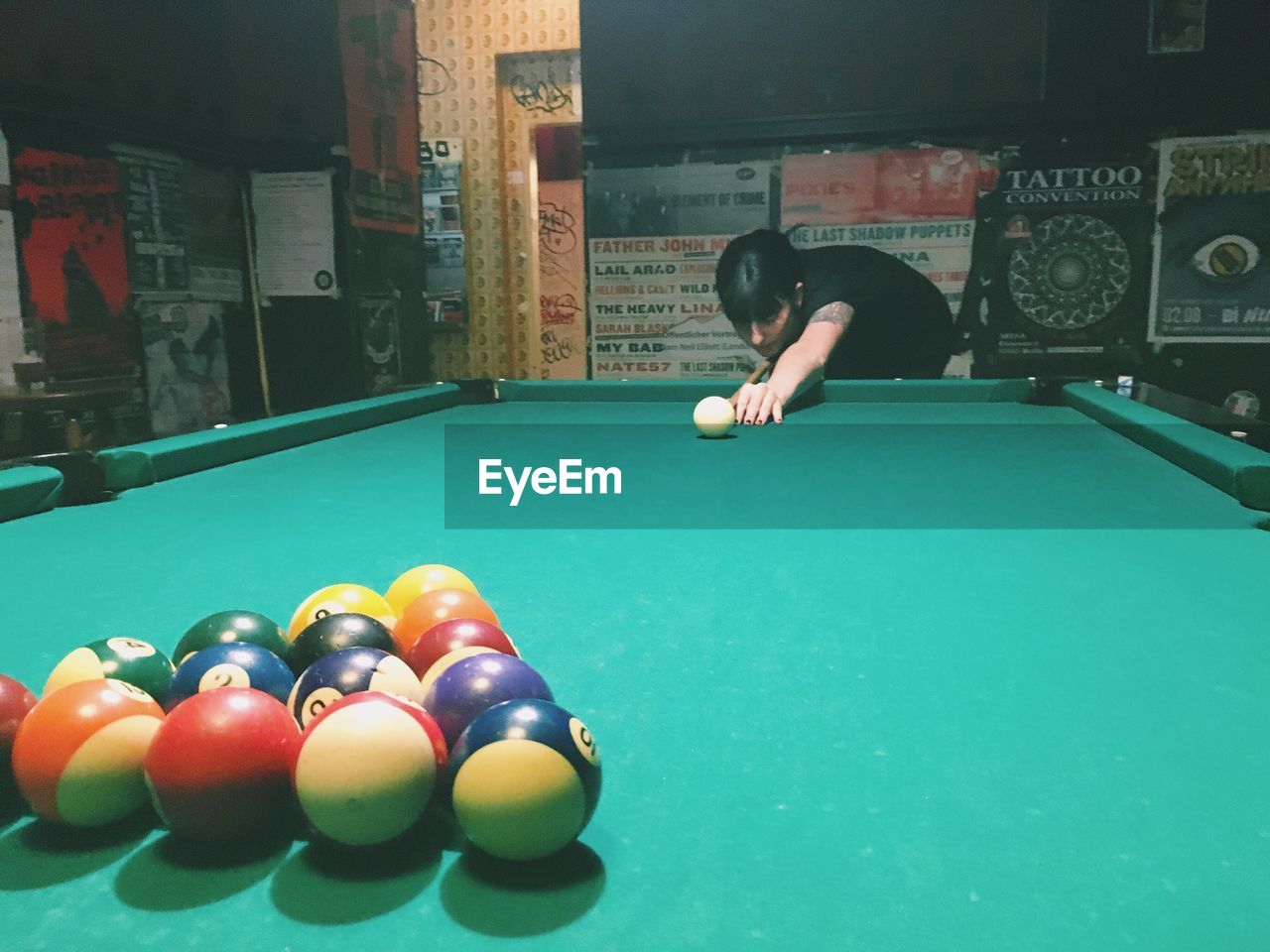 Young woman playing pool