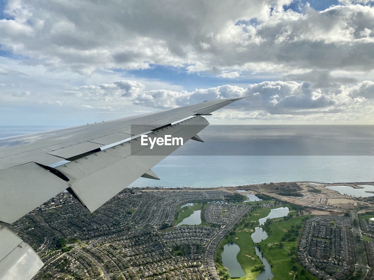 AERIAL VIEW OF SEA AND AIRPLANE FLYING IN SKY