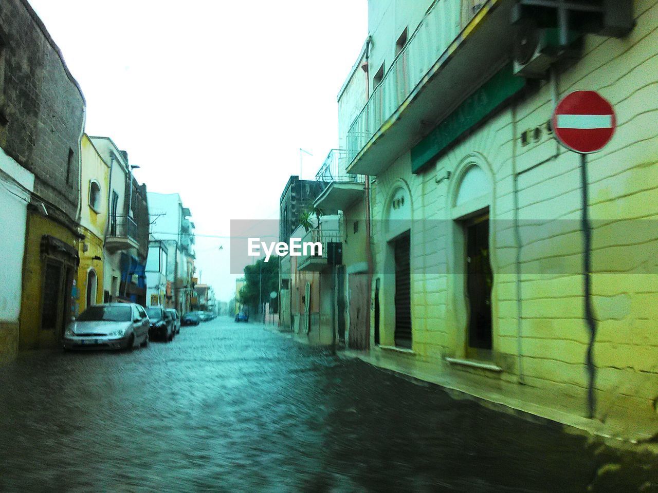 NARROW STREET LEADING TOWARDS BUILDINGS