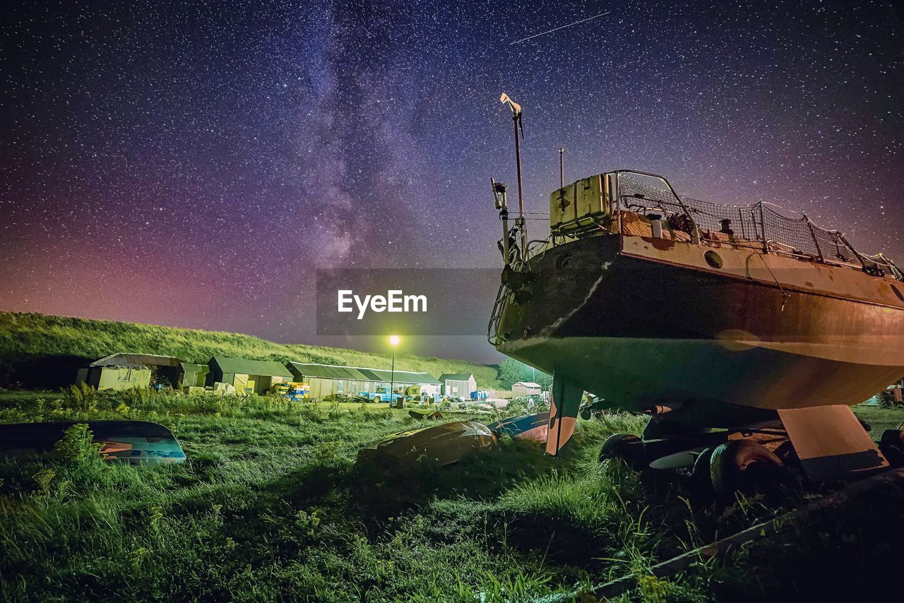 SCENIC VIEW OF ILLUMINATED STAR FIELD AGAINST SKY AT NIGHT