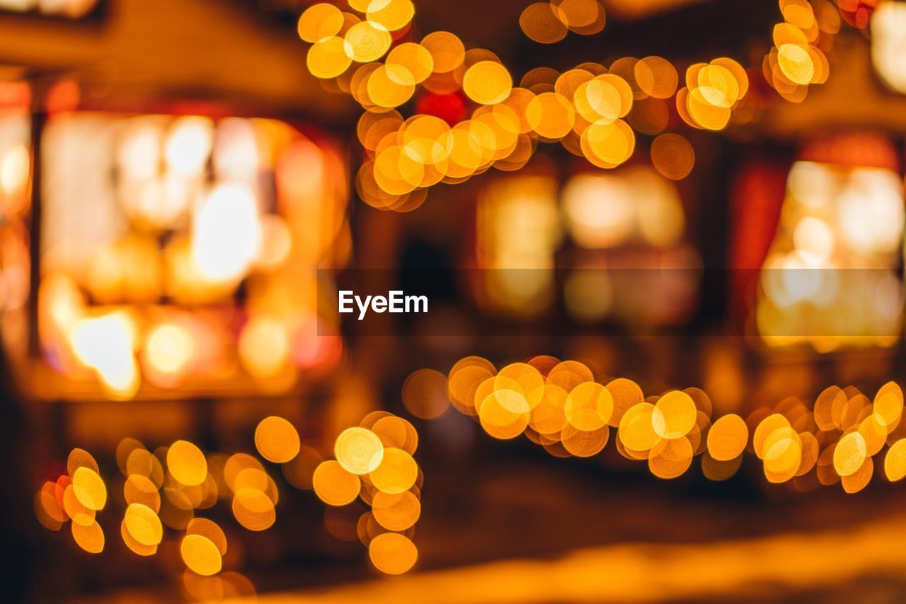 Defocused image of illuminated christmas lights at night