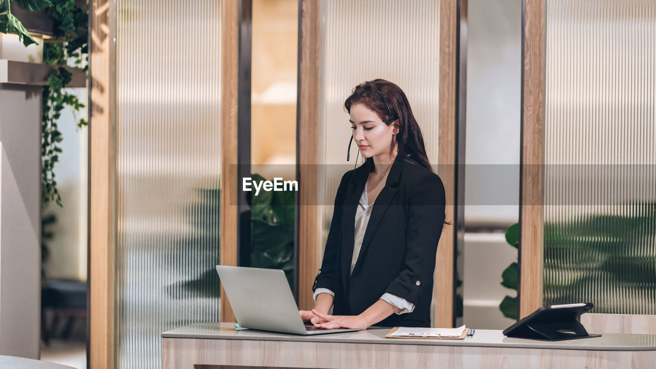 Receptionist and businessman at hotel front desk