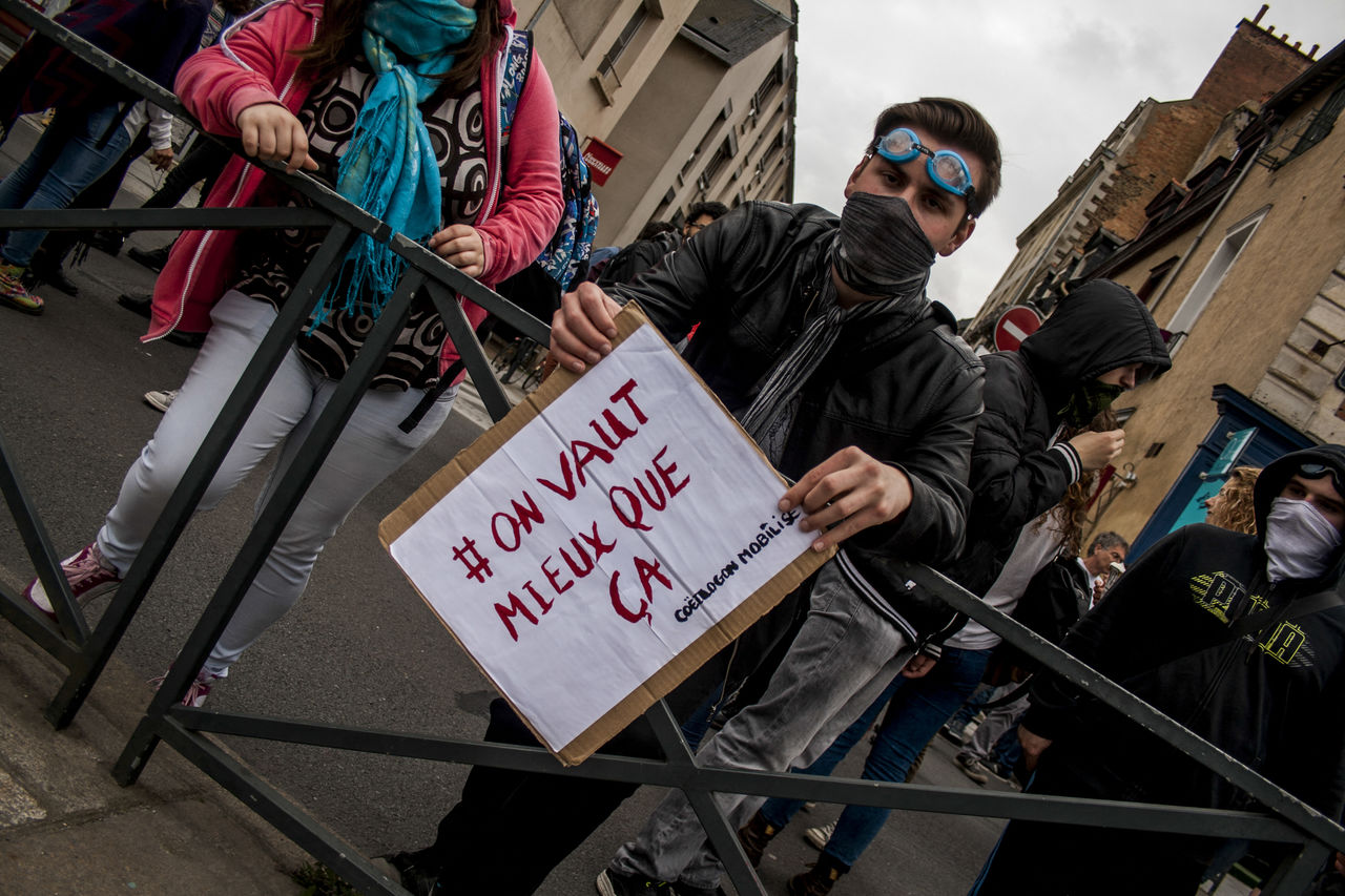 protest, crowd, architecture, street, communication, city, text, social issues, adult, men, sign, clothing, law, building exterior, person, built structure