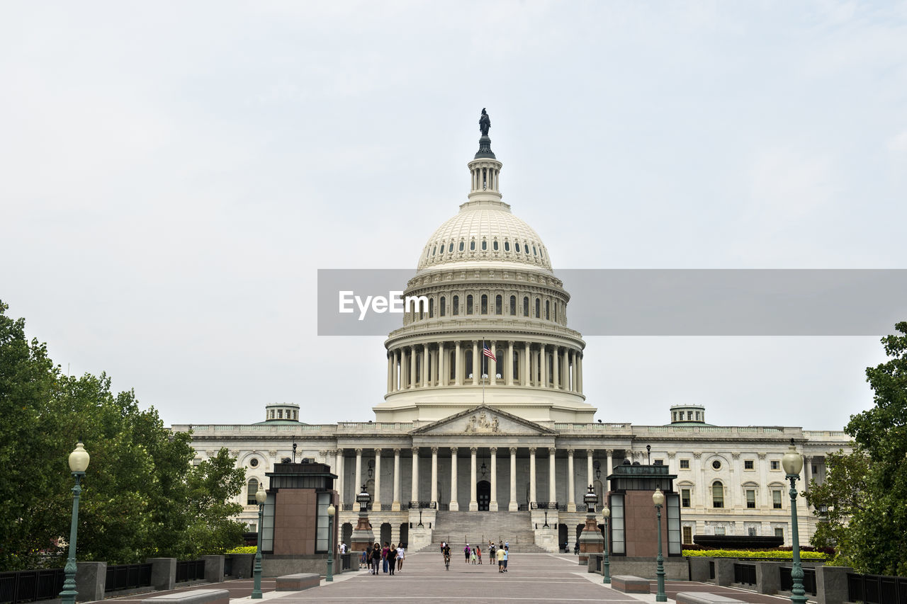 Low angle view of government building against cloudy sky