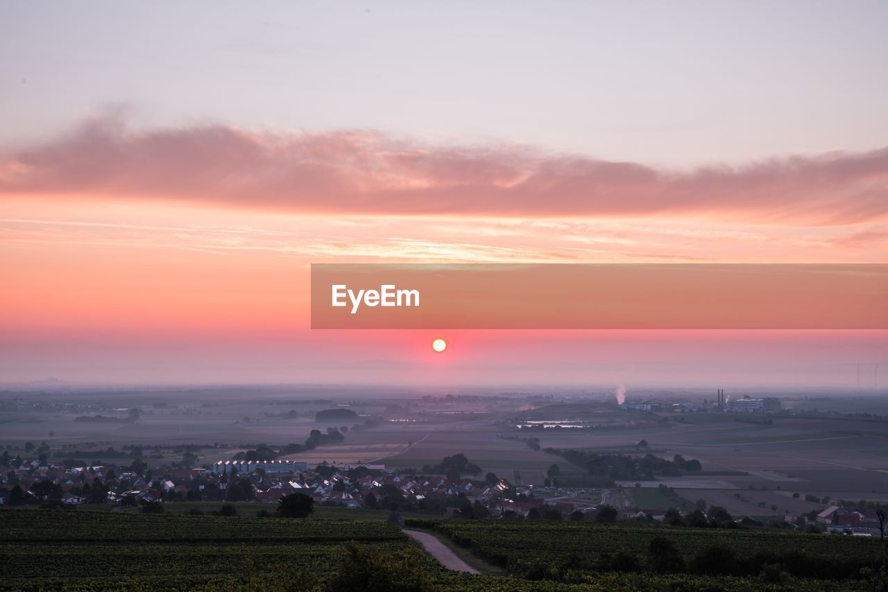 Scenic view of field against sky during sunset