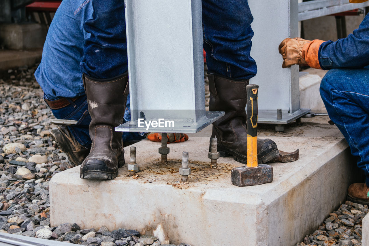 Low section of man working on floor