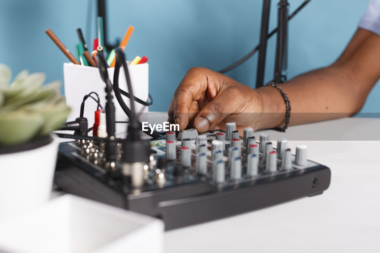 cropped hand of man working at desk