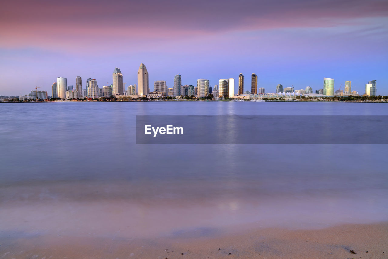 Sea with buildings in background