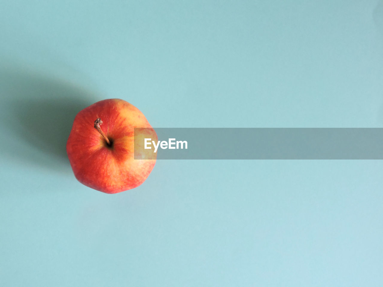 Close-up of apple against blue background