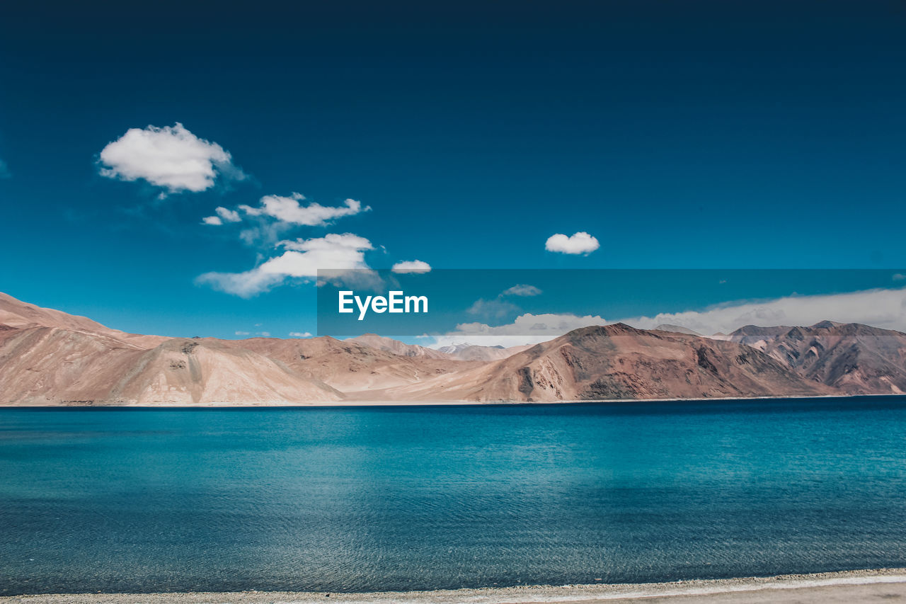 Scenic view of lake against blue sky