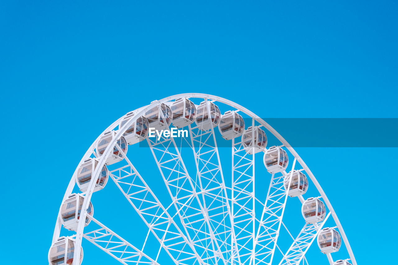Ferris wheel against a clear blue sky