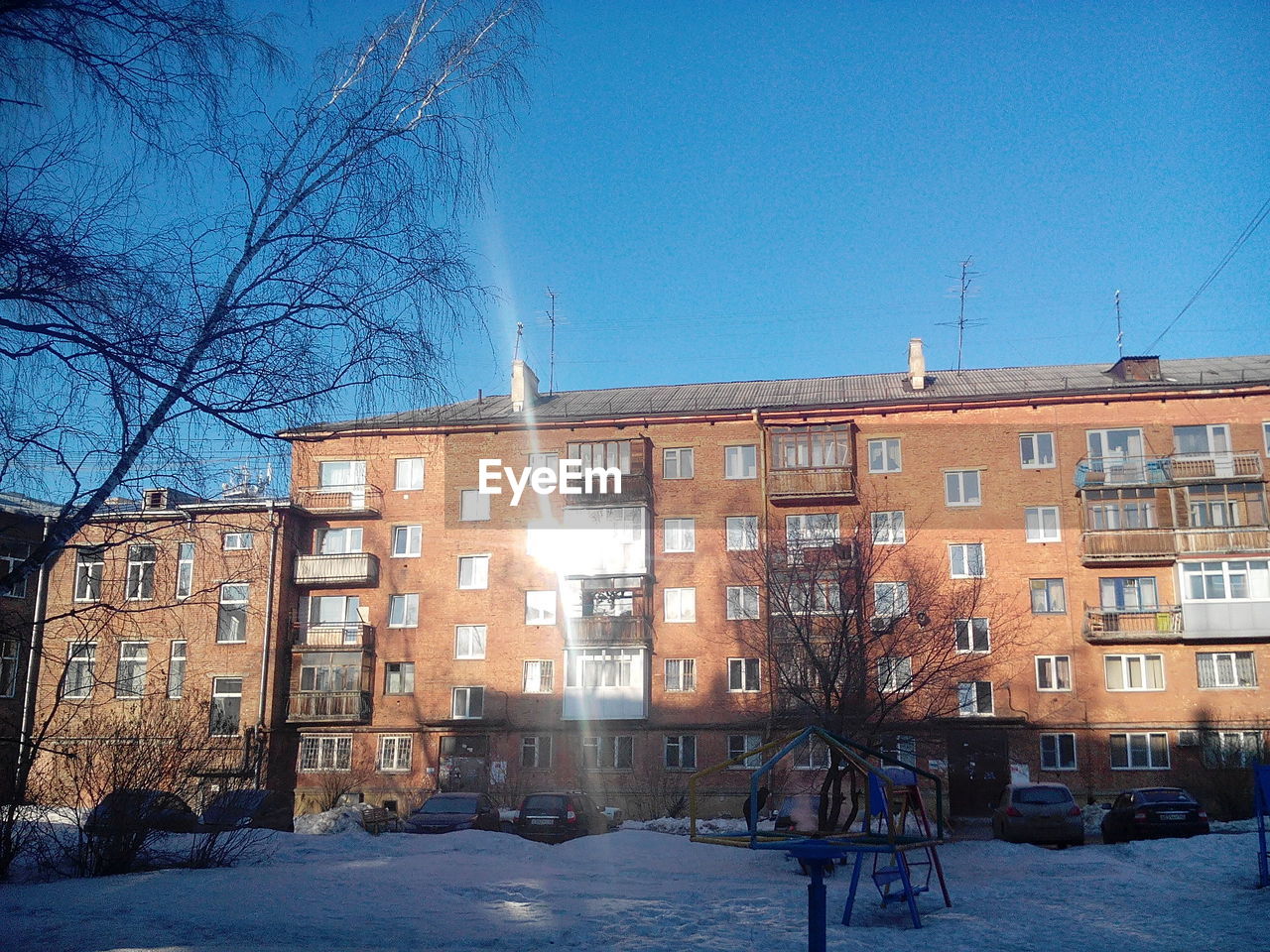 Houses in town against cloudy sky