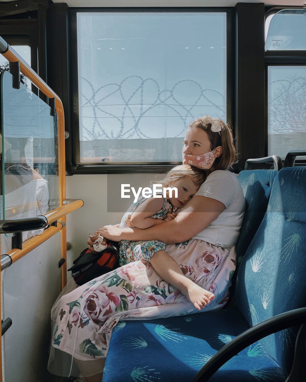 WOMAN SITTING ON WINDOW WITH HANDS