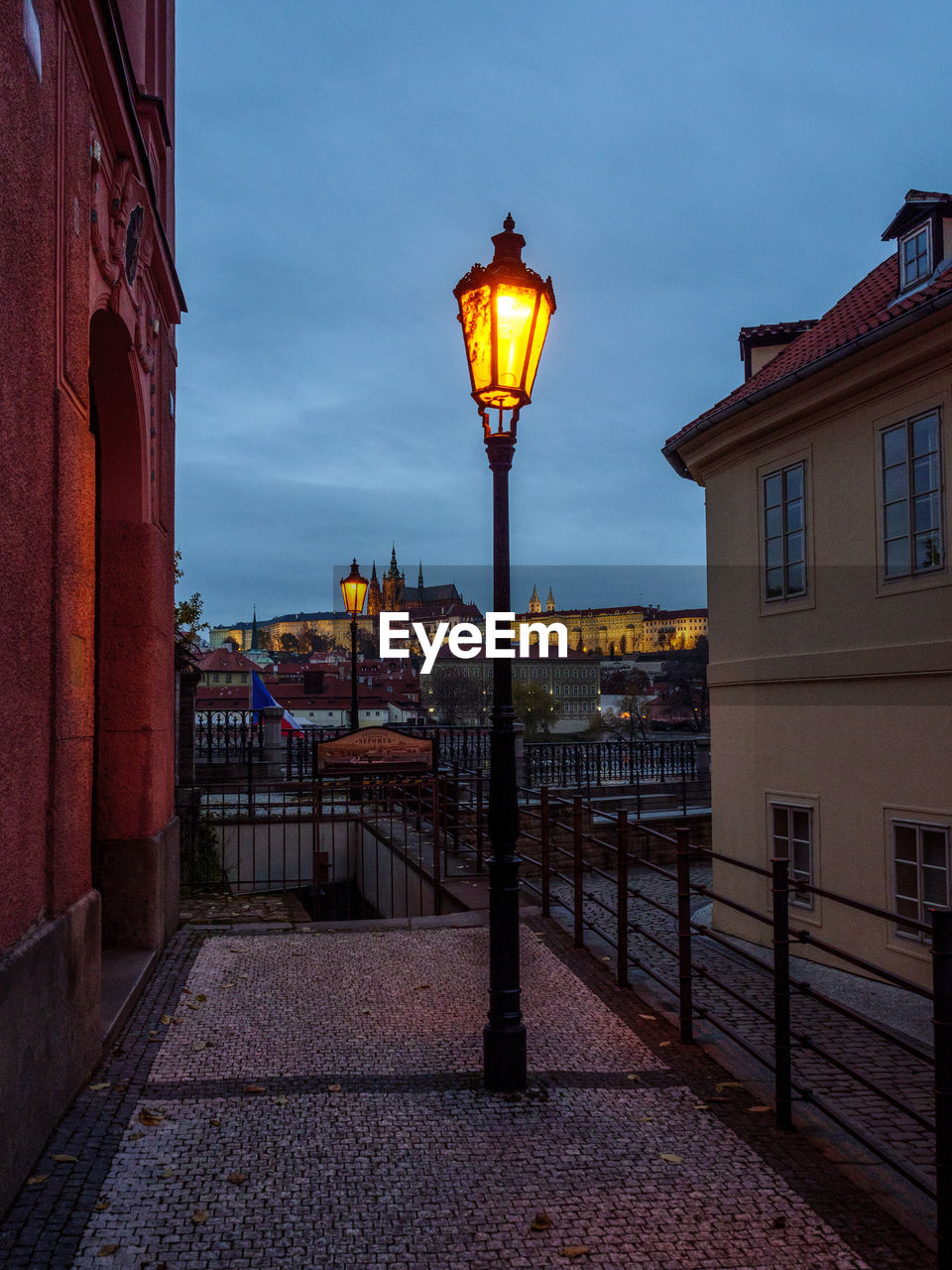 STREET LIGHT BY BUILDINGS AGAINST SKY