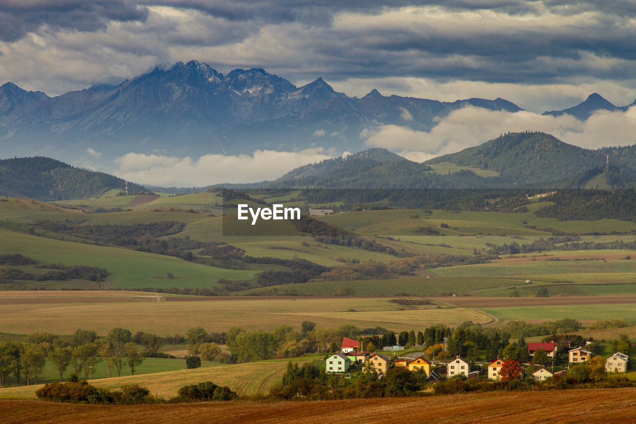 Scenic view of field and mountains against sky