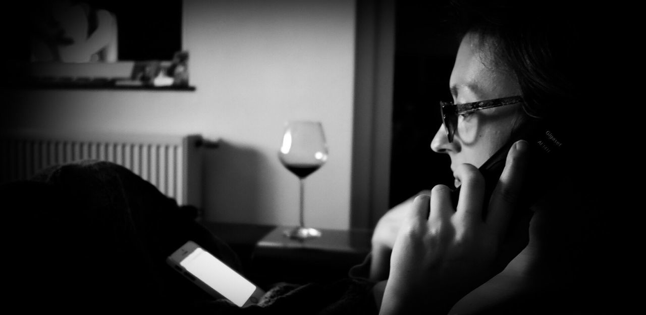 Close-up of woman using phone at home